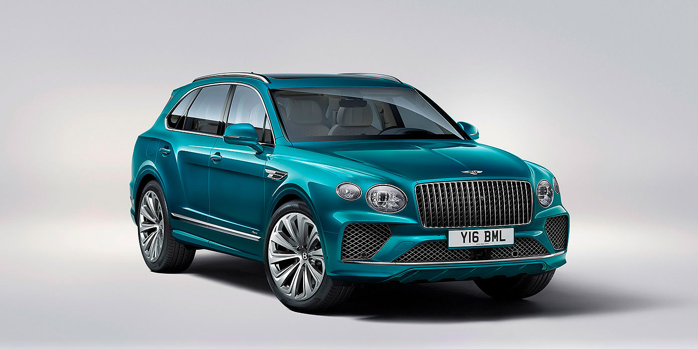 Bentley Geneve Bentley Bentayga Azure front three-quarter view, featuring a fluted chrome grille with a matrix lower grille and chrome accents in Topaz blue paint.