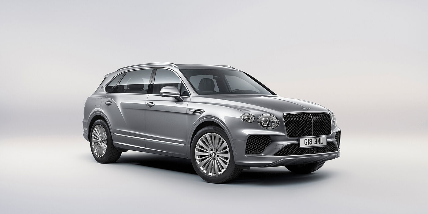Bentley Geneve Bentley Bentayga Extended Wheelbase luxury SUV front three quarter view in Moonbeam paint with 21 inch five spoke painted wheels