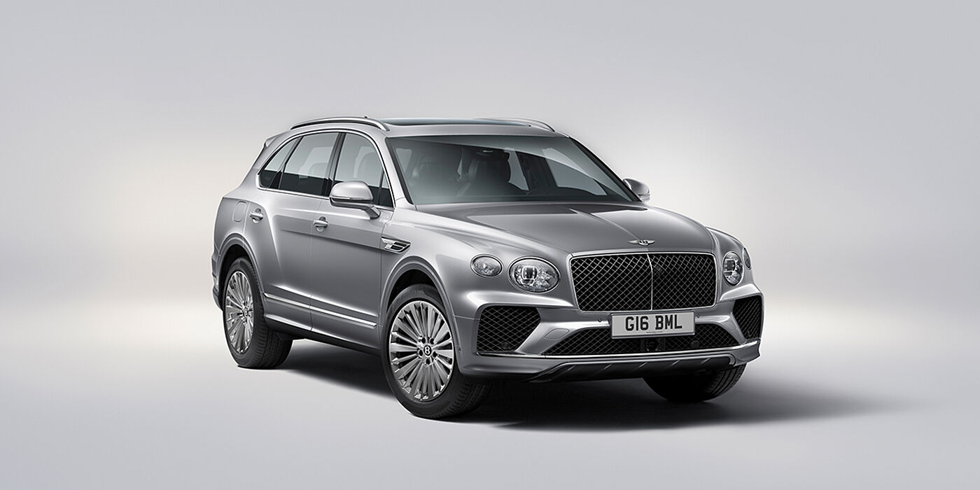 Bentley Geneve Bentley Bentayga luxury SUV front three quarter view in Moonbeam paint with matrix grille and 21″ 5 spoke painted wheels