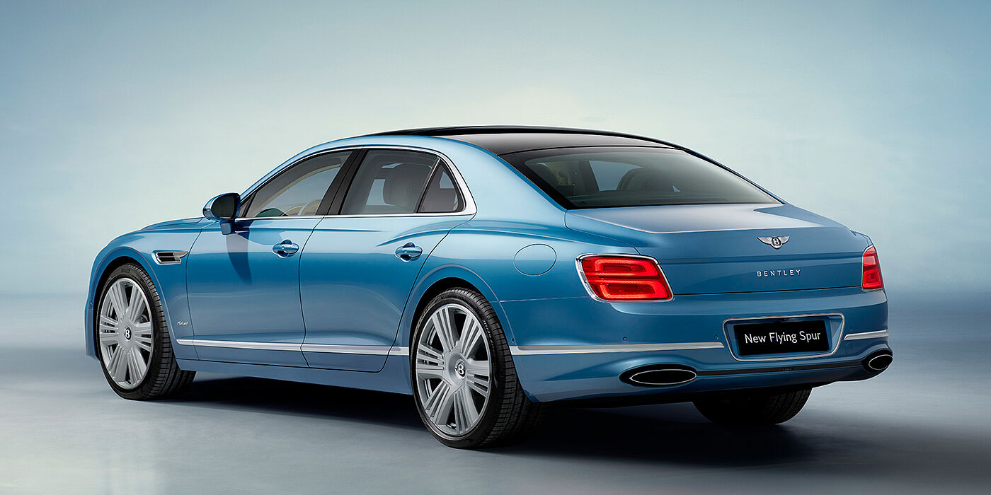 Bentley Geneve New Bentley Flying Spur Azure sedan rear view in Light windsor blue by Mulliner paint with 22 inch Azure wheels and chrome exterior details