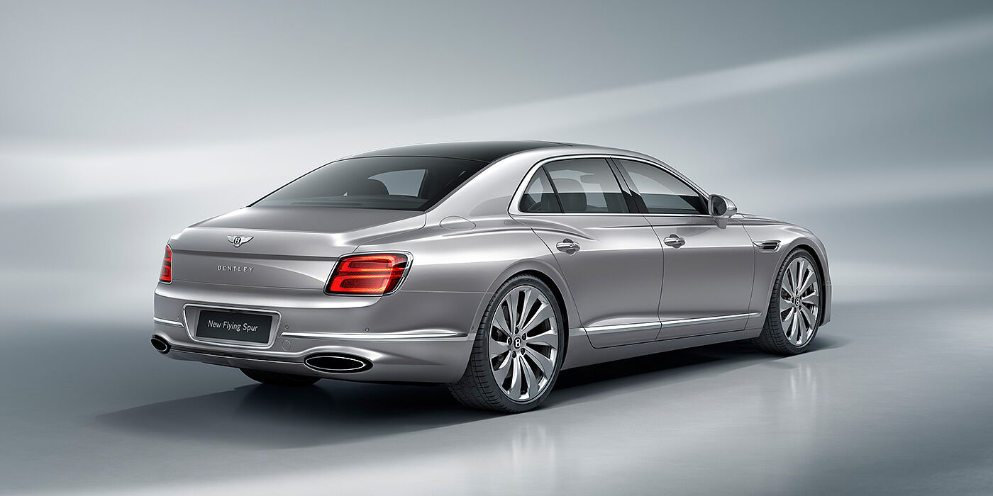 Bentley Geneve New Bentley Flying Spur sedan rear view in Silverlake paint with ten spoke wheels and chrome matrix grille
