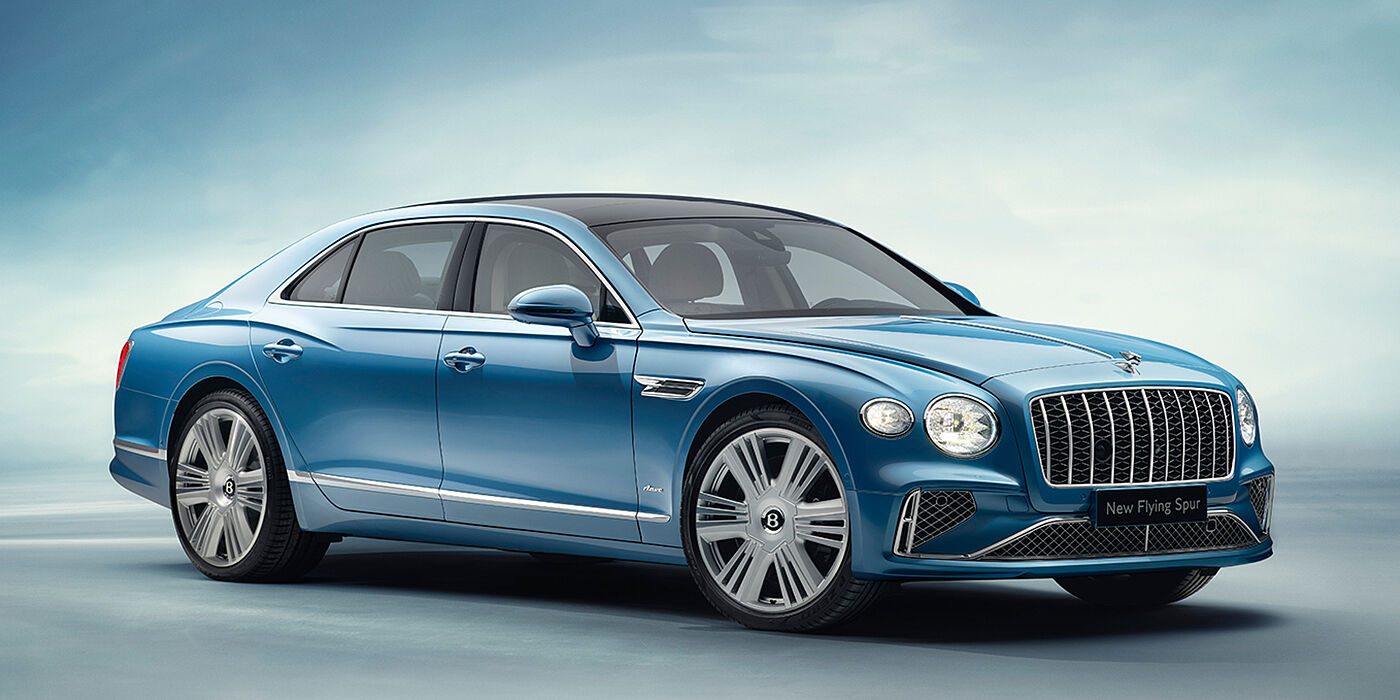 Bentley Geneve New Bentley Flying Spur Azure sedan front view in Light windsor blue by Mulliner paint with 22 inch Azure wheels and chrome exterior details