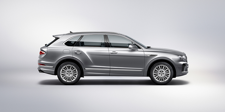 Bentley Geneve Bentley Bentayga SUV side profile in Moonbeam silver paint against white background featuring 21 inch 5 spoke wheels
